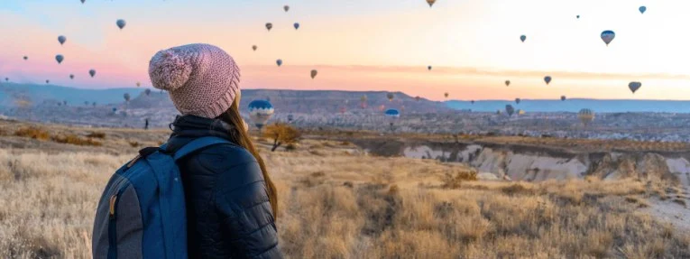 Girl watching hot air balloons in Cappadocia, Turkey